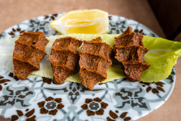 Cig Kofte (raw meatball in Turkish) with lettuce, traditional Turkish cuisine popular in Turkey