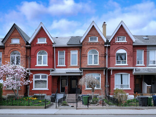Urban residential street with row of attached old houses with gables - 503025069