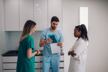 Fototapeta premium Group of doctors looking at x-ray image from jaw