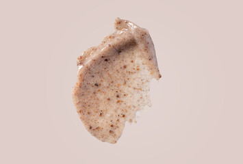 Scrub smear swatch isolated on beige background. Peeling cream smudge with exfoliating particles....