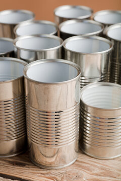 recycling of cans for home on rustic wooden table, brown badground, second life to aluminum cans