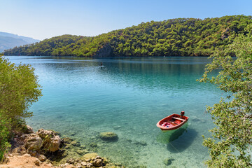 Boat moored on the shore of Blue Lagoon, Oludeniz, Turkey
