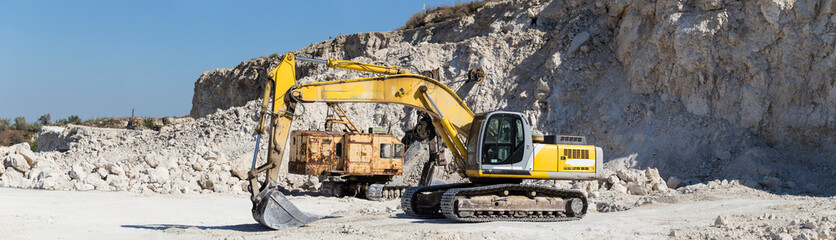 Yellow excavator - digging machine for digging and dumping the soil. Work in the quarry.