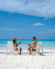 couple men and women on the beach with coconut drink Praslin Seychelles tropical island with withe...