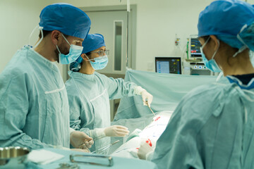 Surgeon and nurses operating a patient