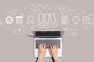 Compliance theme with person using a laptop computer