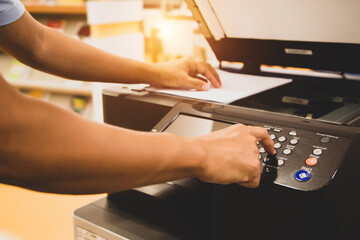 Copiers printer, Close up hand office man press copy button on panel to using the copier or photocopier machine for scanning document printing a sheet paper and xerox photocopy.