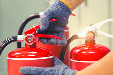Fire extinguisher has hand engineer inspection checking handle of Fire extinguishers to prepare...