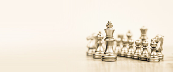 Close-up king chess stand with queen on chessboard concepts of leader teamwork volunteer challenge of business team or wining and leadership strategy and organization risk management or team player.
