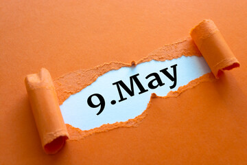 May 09. 9th day of the month, calendar date. written under torn paper.