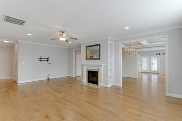 Interior of empty dining space old architecture white beam ceiling built in fireplace mirror