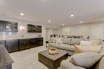 Living area traditional bar tile backsplash light fixture black cabinets yellow accent pillow gray grey couch