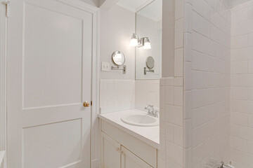 bathroom with tiles pull out mirror old fashion white vanity sink 