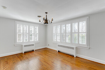 empty room with window plantation shutters black chandelier gothic gas heater