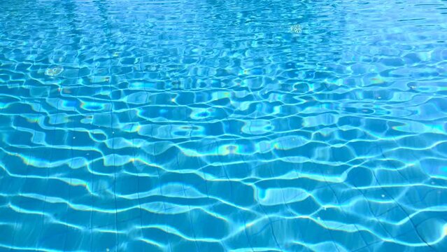 Slow motion video movement of blue water in a large swimming pool Quality and clean swimming pool