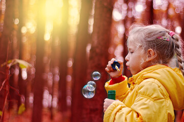 Bubble. Girl blowing soap bubbles.