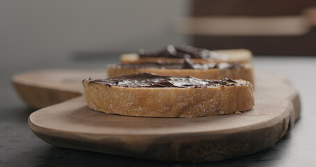 chocolate spread on ciabatta slice on olive board