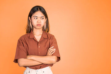 young woman stand cross hand with unhappy sad face on isolated background