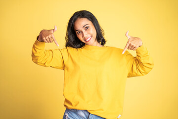 attractive asian woman with finger pointing down hand gesture on isolated background