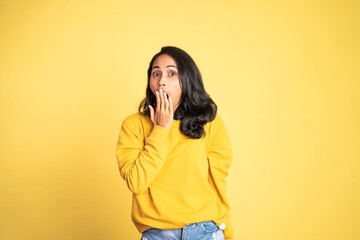 portrait of young asian woman feeling shocked and suprised over isolated background