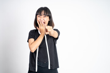 beautiful woman with finger pointing at frong and laughing at something isolated background