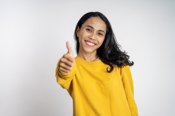 attractive smiling young woman stand with thumbs up on isolated background