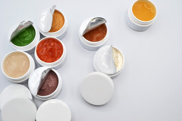 Fototapeta na wymiar natural ingredient skin care jars opened on white background