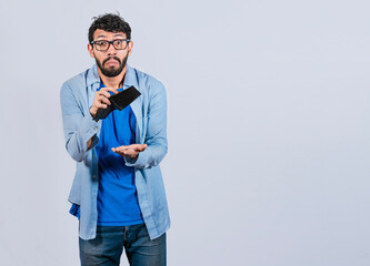Sad man holding empty wallet and looking at the camera, Unhappy and surprised man looking into an...