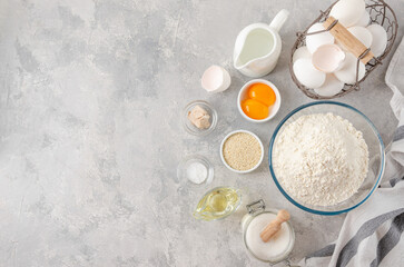 Ingredients for the preparation of challah bread dough, flour, water, sugar, eggs, yeast, oil, salt. Top view, copy space.
