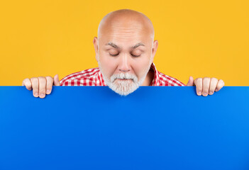 amazed senior man with copy space on blank banner. advertisement