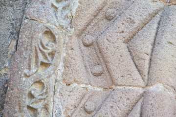 sandstone carvings in the entrance arch of a Romanesque style church. church of Santa Olaya de Selorio, Asturias, Spain. master stonemasons - obrazy, fototapety, plakaty