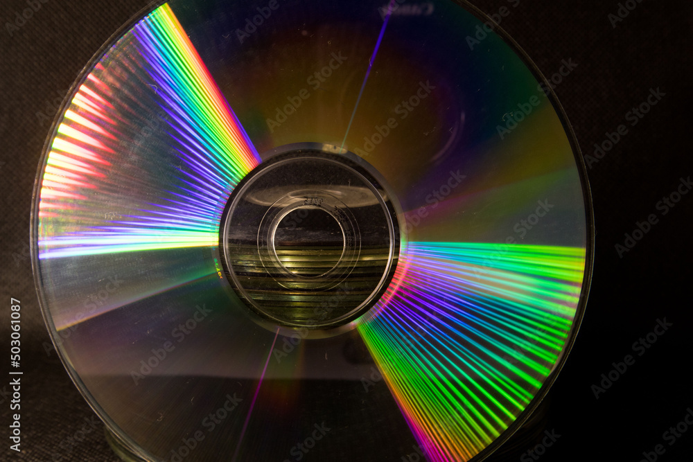 Poster reflection of light in a compact disk(cd) or digital versatile disk(dvd).