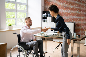 Businessman Shaking Hands With Disabled Businesswoman