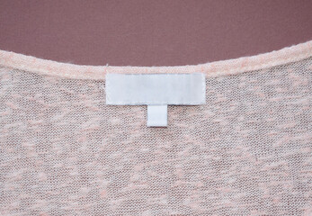 White empty label on fabric clothes.