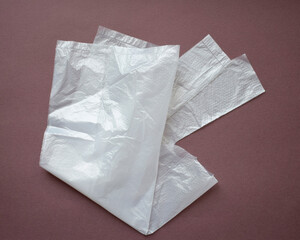 New closed disposable transparent plastic bag on a dark background.