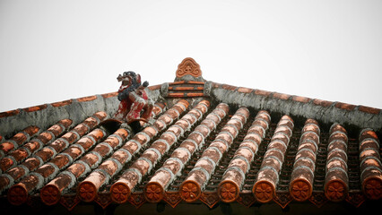 Closeup shot of the Okinawa shisha sittings on a traditional Okinawan red ceramic tile roof