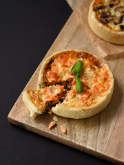 Delicious mini salmon pie with crispy pie crust and mushroom pie on background