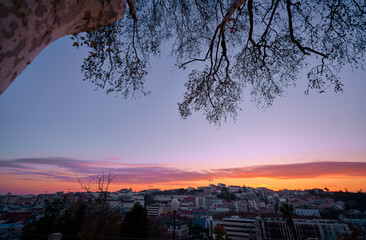 Beutiful view of old town in Lisbon. Red tiled roofs and sunset sky.