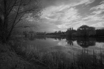 Fototapeta premium Beautiful black and white landscape of the lake in the village