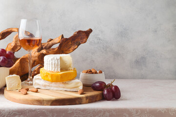 Cheese, grapes, nuts and wine on table