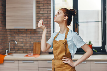 woman in an apron in the kitchen housework unaltered