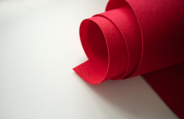 Photo of red felt fabric on white isolate.Sale of fabric for sewing. Fabric store.Red felt.