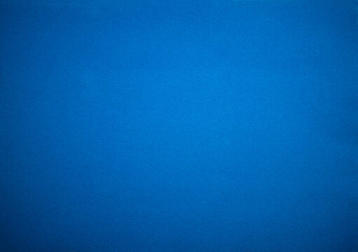Photo of the texture of the blue fabric. Felt background is blue with a blue vignette.
Blue background for text or ad.