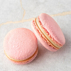 Sweet Strawberries macarons on a stone background. Traditional French dessert