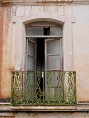 Fototapeta na wymiar Close up of window and balcony of crumbling building in Ayna. Albacete, Castile La Mancha, Spain.