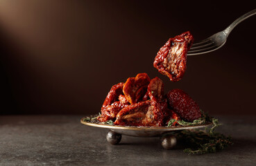 Sun-dried tomatoes with thyme in olive oil.