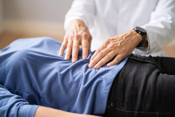 Gastroenterologist Doctor Consulting Woman In Clinic