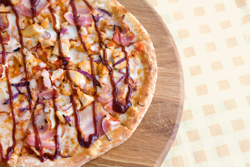 Pizza with bacon on a wooden background. Foodphoto, top view