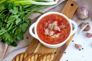 Borscht with meat and garlic on the table. Light food photography, top view