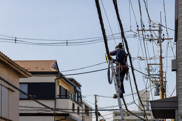 街中の電線の工事をする作業員